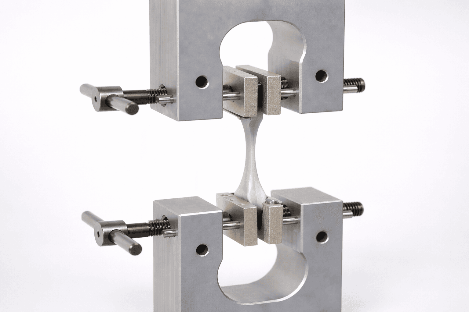 Aluminum tensile test rig with a 3D printed dogbone specimen stretched between two grips — the mechanical test used to verify every material on the TAKT 3D floor