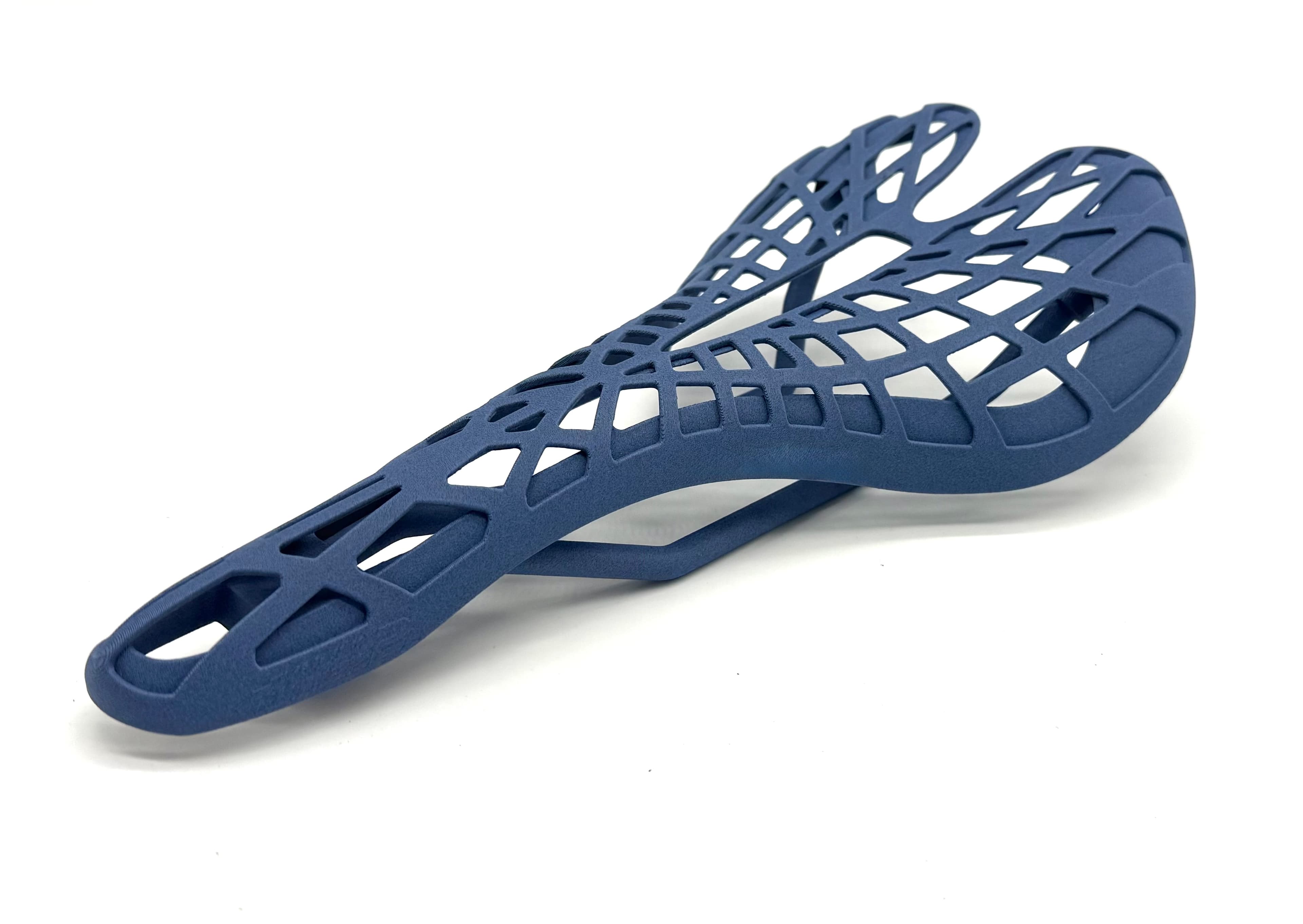 Carbon fiber 3D printed bicycle saddle with exposed generative lattice structure, printed at TAKT 3D in San Diego